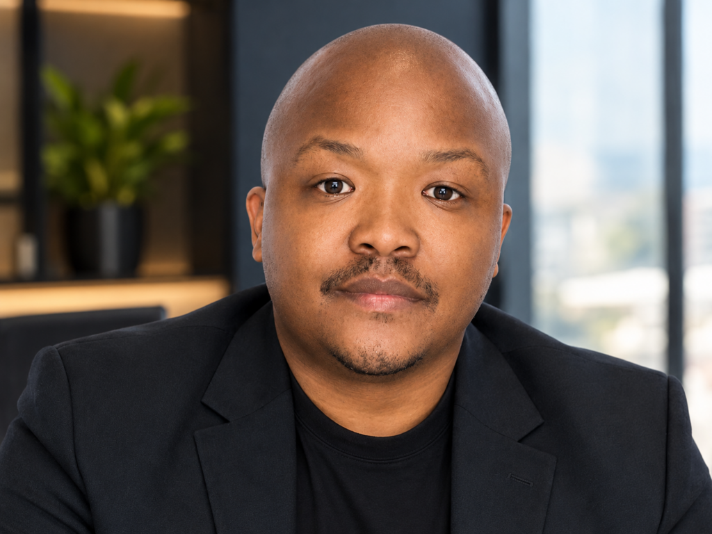 Founder of Consult Centa Mr. Manna Vika. African male in his 30's wearing a black suit
